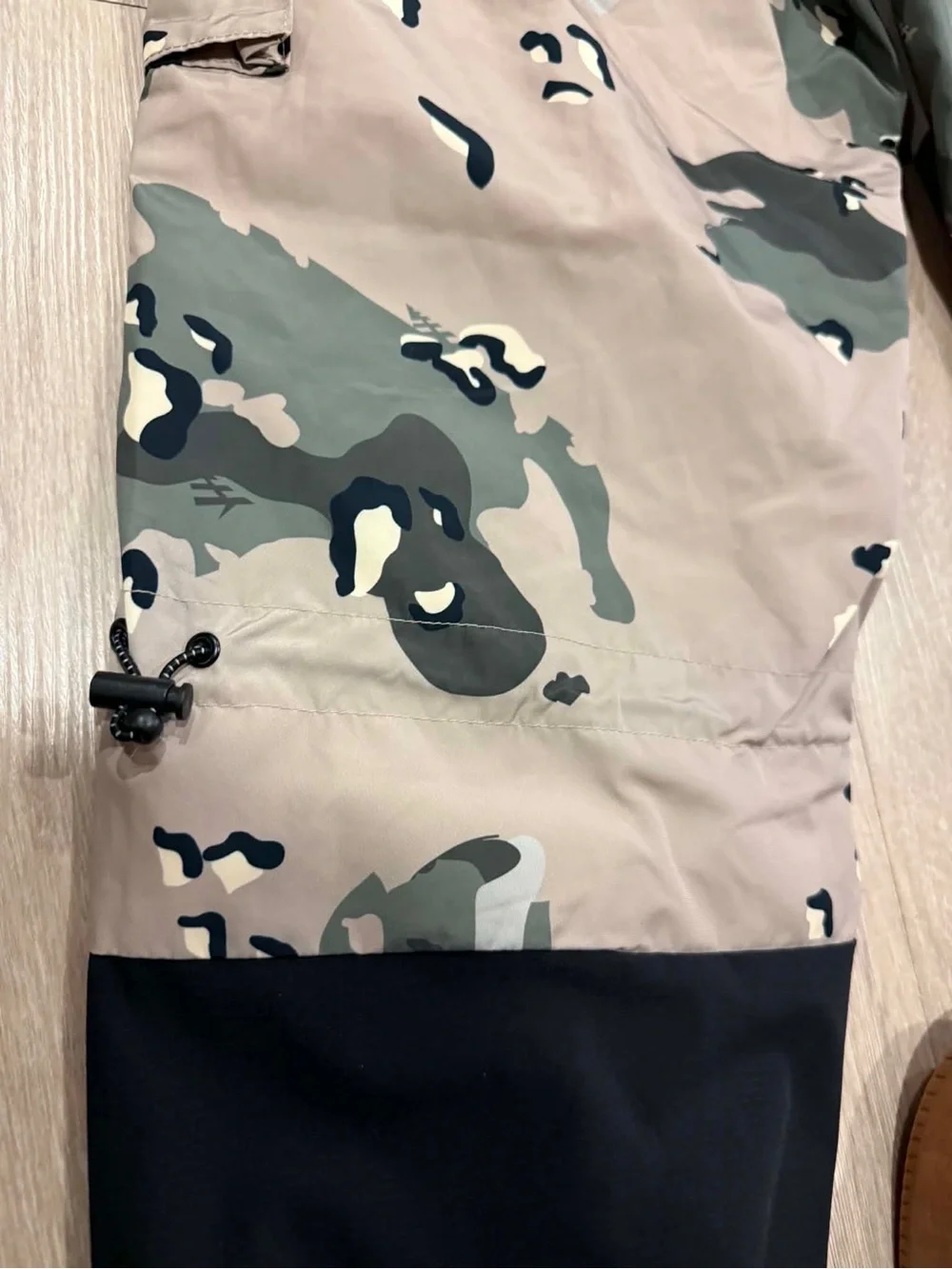 Paper Planes multi-pocket cargo pants featuring an all-over camouflage print